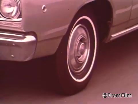The still features a Dodge vehicle, likely from the late 1960s. The design elements such as the body shape and wheel style suggest it may be around 1966-1969. In this era, Dodge produced several models that were popular among car enthusiasts, particularly in the drag racing community. If you need a precise year, consider the specific features of the car.