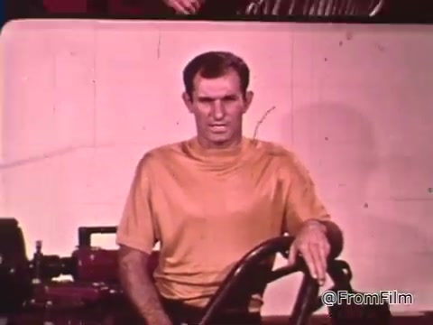 The still you're describing features Don Garlits, a renowned drag racer, speaking about car maintenance in the context of drag racing. He emphasizes the importance of having a car in top condition to succeed in races, such as the NHRA championship.   As for the Dodge mentioned, without specific details about the model, it's challenging to pinpoint an exact year, but classic Dodges from the 1960s often featured powerful engines and distinctive designs prominent in drag racing during that era.
