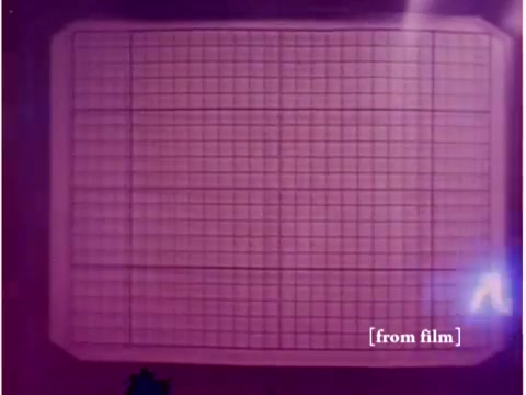 The still depicts an oscilloscope screen displaying a grid pattern, with a pinkish tint likely due to the film being a silent negative from a defunct lab. This image is a part of a 1967 Bell System film focusing on preventing data transmission errors, featuring various technological elements from that era, such as computers and acoustic modems. The lab defect may obscure some details, but the overall presentation highlights the technology used for data analysis at the time.