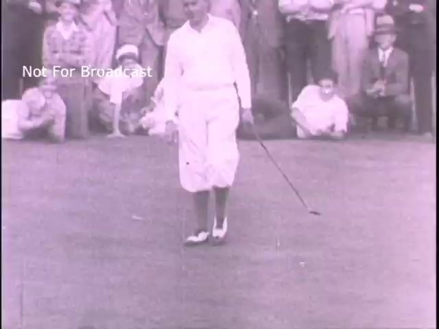 The still depicts a golfer in a white outfit, including long pants and shoes, walking on a golf course. A crowd is visible in the background, observing the game. The image likely reflects the sporting culture of the era, perhaps tying into themes of discipline and camaraderie that were promoted by military recruiting campaigns in the 1960s. The visual style suggests a vintage aesthetic typical of the period.