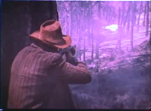 The still from the 'Showdown' trailer features a figure wearing a hat, possibly in a wooded landscape. The character appears to be aiming a rifle, suggesting tension or anticipation. The color palette has a purple hue, likely due to the aging of the 16mm print, giving the scene a vintage feel. The overall atmosphere hints at a dramatic or suspenseful moment within the context of the film.