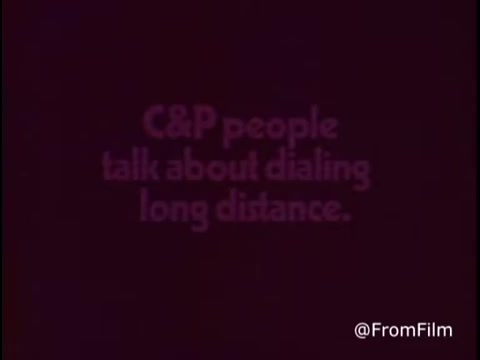 The still features a simple, text-based graphic reading 'C&P people talk about dialing long distance.' The font is bold and emphasizes the topic of discussing long-distance communication, likely highlighting the role of C&P Telephone during that era. The background is a muted color, enhancing the visibility of the text. This commercial captures a nostalgic moment from the early 1970s, focusing on personal connections facilitated by telecommunication.   Follow us on Twitter @FromFilm.