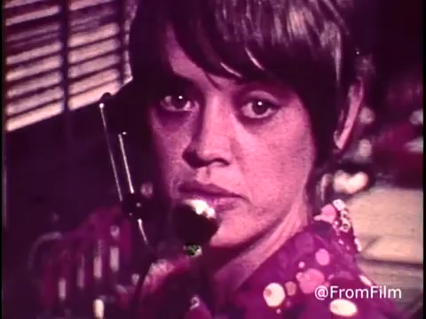 This still from the C&P Telephone commercial features a close-up of a female operator at a cord board, capturing her focused expression while handling a call. The vintage 16mm print showcases the stylistic elements of the early 1970s, with muted colors and a nostalgic, retro aesthetic. The scene reflects the era's communication practices, emphasizing the human element of long-distance dialing. Follow @FromFilm for more insights!