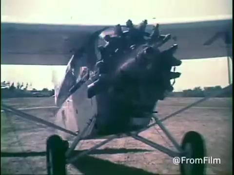 The still from the 1970s Kellogg's Shredded Wheat commercial shows a close-up of a vintage airplane, highlighting its propeller and front fuselage. The image captures the essence of the era with a nostalgic color palette typical of 16mm film, likely emphasizing themes of simplicity and wholesome living associated with the product.   For more insights, follow @FromFilm on Twitter.