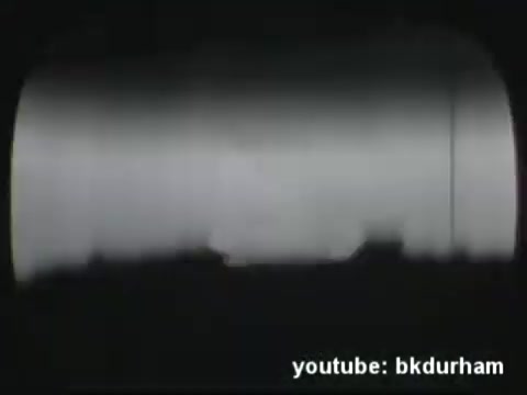 The still appears to be a frame from a 16mm kinescope recording of a religious TV show from the 1950s, likely based in San Diego. Kinescopes were used to record live television broadcasts before videotape technology became prevalent, capturing the unique aesthetic of the era. The image likely features a dimly lit scene, characteristic of early TV production quality, possibly with outlines or shadows indicating figures or set pieces. This captures the nostalgic essence of mid-century broadcast television.