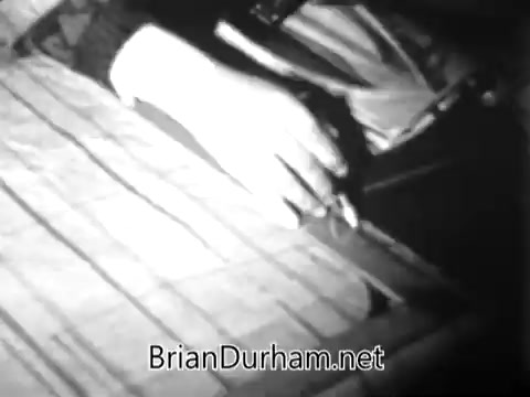 The still from the 'Catholic Bishops' Overseas Aid Fund PSA' depicts a hand resting on a textured surface, possibly a table or a map. The image likely symbolizes the connection between the viewer and the issues of hunger and poverty faced in overseas regions. The context emphasizes the contrast between abundance in some areas and scarcity in others, highlighting the need for support to bridge this gap. The hand's presence may represent a call to action, urging viewers to contribute to relief efforts.