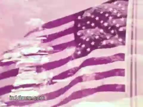 The still from the 'Freedoms Foundation PSA with Anita Bryant - 1968' features a stylized American flag, possibly in a sepia or muted color palette. The context includes a sung portion invoking patriotism, followed by Anita Bryant's voiceover, referencing the historical significance of Valley Forge and George Washington's struggle during the Revolutionary War. The visuals likely emphasize themes of American pride and the enduring spirit of freedom.