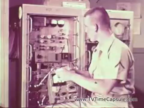 The still features a Marine in a light-colored uniform seated at a technical workstation, focused on operating or inspecting electronic equipment within a bulky console. The setting suggests a mechanical or technical environment, typical of military training during the Vietnam era, highlighting the Marine Corps' emphasis on skill development. The overall tone promotes the message of personal growth and vocational training provided by the Marine Corps.