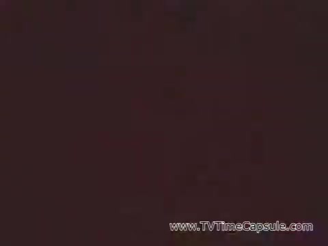 The still from 'Marine Corps Recruiting Spot - The Marine Corps Builds Men' likely depicts themes common in Vietnam-era military recruitment ads, focusing on discipline, strength, and camaraderie. The imagery would typically include aspects of training, physical challenges, and displays of patriotism aimed at appealing to young men considering enlistment. The visual style is likely stark and impactful, reflecting the seriousness of military service during that time.