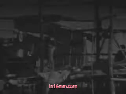 The still from the 'Another 'Foster Parents Plan' PSA - 1960's' appears to depict a stark, perhaps somber scene focusing on a dilapidated structure or environment. The monochromatic tones enhance the mood, suggesting themes of neglect or abandonment. The composition may emphasize the need for intervention or support, aligning with the PSA's intended message about the importance of foster care.