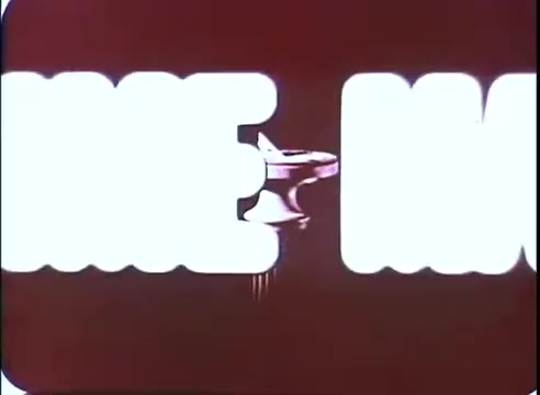 The still from 'The Time Machine' promos features bold, stylized text with a bright, contrasting background. The text appears to emphasize key themes or elements of the film, while a subtle image—likely related to the movie—can be seen partially obscured. The overall aesthetic evokes a vintage promotional style, typical of mid-20th century cinema.