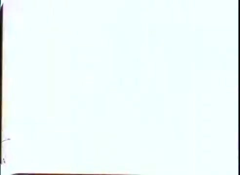 The still is a simple and minimalist image, likely featuring promotional content related to 'The Time Machine.' It appears to have a light or neutral background, possibly with minimal visual elements or text. The focus may be on conveying a sense of intrigue or futuristic themes associated with time travel, typical of the film's promotional material.