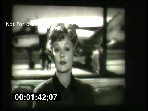 The still from the 'ABC Sunday Night Movie' promos in the 1960s features a prominent woman, likely an actress or host, against a backdrop that suggests a cinematic atmosphere. The image is in black and white, typical of the era, and conveys a classic vibe associated with mid-20th century television broadcasts. The time code at the bottom indicates it's part of a video segment. Overall, it encapsulates the essence of promotional materials from that time, reflecting the style and presentation of movies on Sunday nights.