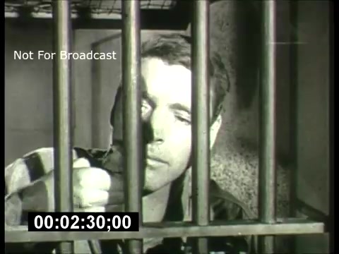 The still from the 'ABC Sunday Night Movie' promos features a scene depicting a man behind bars, likely conveying a dramatic or tense moment. The image is in black and white, reminiscent of the 1960s style, suggesting themes of confinement or struggle. The timestamp indicates a specific point in the promo, and the watermark emphasizes that it's not for broadcast. Overall, it captures the captivating essence of movie promotions from that era.