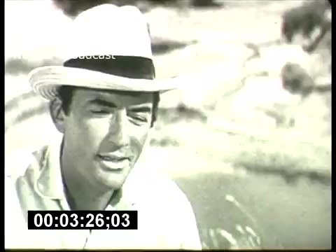 The still from the 'ABC Sunday Night Movie' promos in the 1960s features a black-and-white frame of a man in a light-colored hat, likely engaged in dialogue or a reflective moment. The image captures a sense of nostalgia, indicative of classic cinema style, and is part of promotional material highlighting the era's movie offerings. The timestamp suggests it's a segment within a larger promotional reel.