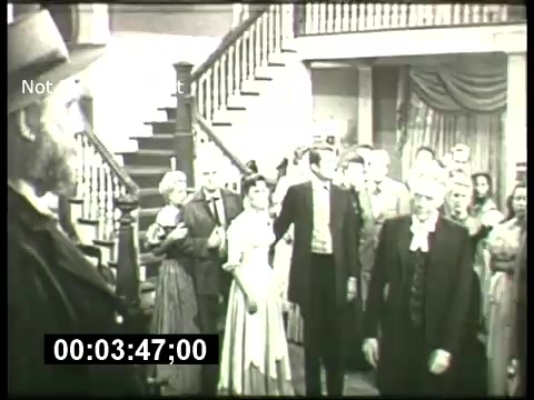 The still appears to depict a scene from a dramatic moment in a black-and-white film, likely part of the ABC Sunday Night Movie promotions from the 1960s. It features a group of characters dressed in period attire, gathered in what seems to be an interior setting with a staircase in the background. The mood looks tense, suggesting a pivotal or emotional scene. The timestamp at the bottom indicates it's a specific moment in the promotional material.