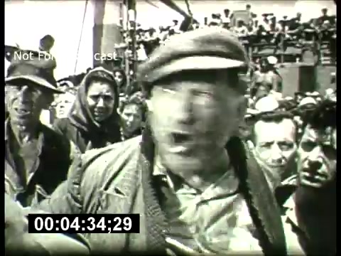The still features a scene from a dramatic moment, likely depicting a conflict or intense situation. A man in the foreground, possibly a leader or speaker, is animatedly expressing himself, while a diverse group of onlookers appears concerned or engaged in the background. The setting seems to involve maritime elements, hinting at a story related to struggle or confrontation. The overall tone suggests a classic film, in line with the promotions typical of the ABC Sunday Night Movie in the 1960s.