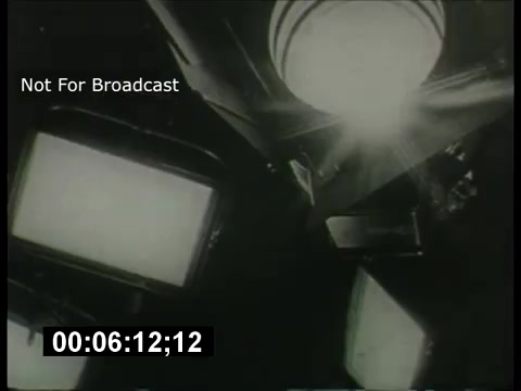 The still from the 'ABC Sunday Night Movie' promos in the 1960s features an upward perspective, capturing studio lights and television screens. The lighting suggests a theatrical atmosphere, indicative of the promotional style of that era. The overlay indicates it is not for broadcast, and there's a timecode present. Overall, it evokes a nostalgic feel associated with television promotions from that time.
