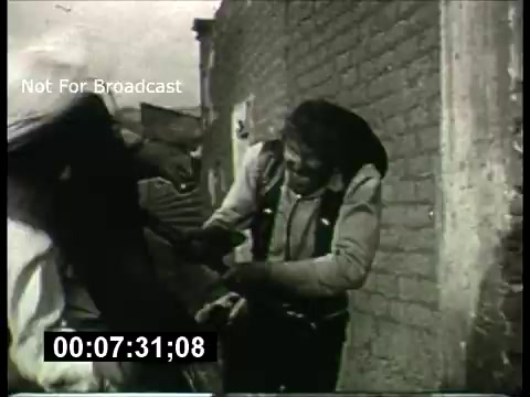 The still from the 'ABC Sunday Night Movie promos - 1960s' features a dramatic scene in a gritty urban setting. It showcases characters engaged in a tense interaction, emphasizing action and suspense typical of film promos from that era. The black-and-white image reflects the visual style of the time, with a sense of urgency and raw emotion conveyed through the actors' expressions and body language. The overlay text indicates it's not meant for broadcast.