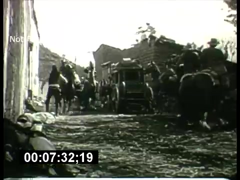 The still appears to be a scene from a classic Western or historical film featured in the ABC Sunday Night Movie promos from the 1960s. It shows a dusty street with a horse-drawn carriage and mounted riders, suggesting action or conflict. The monochrome aesthetic, typical of older films, adds a vintage feel to the image, along with the cinematic framing and timing indicator at the bottom. Overall, it captures the essence of the era's movie promotions.