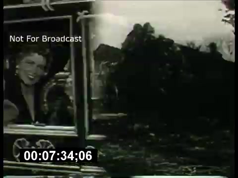 The still features a promotional segment from the 'ABC Sunday Night Movie' in the 1960s. It presents a split screen: on the left, there's a lively image of a woman, likely a host or actress, smiling at the viewer. The right side displays a more somber scene, possibly from a movie being promoted. Both images are overlaid with text indicating 'Not For Broadcast' and a timecode. The overall aesthetic reflects the vintage style of television promotions from that era.