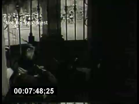 The still from the 'ABC Sunday Night Movie' promos in the 1960s features a dramatic scene likely depicting tension or suspense. It shows a dimly lit interior, possibly a jail or prison cell, with bars in the foreground. The composition suggests a narrative focus, possibly highlighting the emotional state of a character. The timestamp indicates it's part of a longer promotional segment. Overall, the image captures the classic cinematic style of the era.