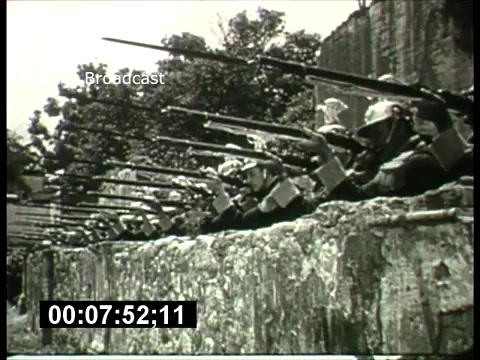 The still from the 'ABC Sunday Night Movie' promos depicts a group of soldiers or military personnel in a defensive position. They are equipped with rifles and are positioned behind a wall or barricade, suggesting a tense or combative scene. The image likely reflects the type of dramas or historical narratives that were popular in 1960s television programming, designed to engage viewers with action and suspense. The black-and-white format adds to the period authenticity, capturing the era's cinematic style.
