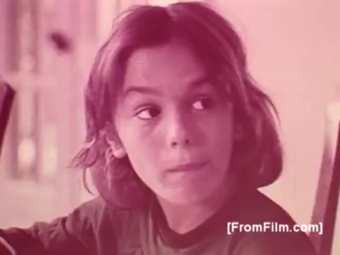 The still depicts a young boy with medium-length hair, looking thoughtfully off to the side. The scene likely captures an intimate moment, possibly evoking nostalgia or curiosity related to the warmth and comfort associated with Knorr Caldo De Galinha soup. The overall tone is soft, characteristic of the 1970s aesthetic, with muted colors typical of a 16mm film print.