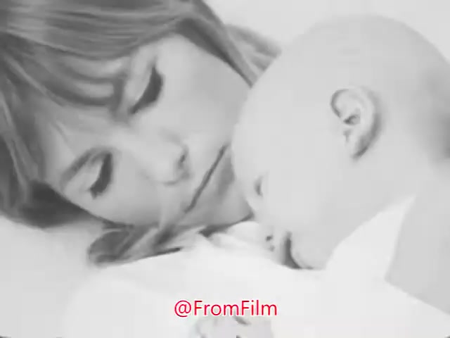 The still from 'A Matter of Life or Breath' features a woman tenderly cradling a baby, capturing a moment of innocence. The soft expressions convey warmth and care, contrasting with the urgent call to action against air pollution. The voice-over emphasizes the importance of clean air for future generations, urging viewers to join the fight for environmental health.