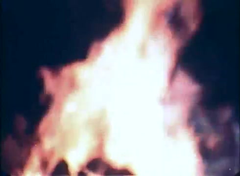 The still features a bright, intense fire, suggesting a moment of tension or danger. The chaotic flames may symbolize the impending threats faced by the characters in 'Race with the Devil.' The use of 16mm film captures a gritty, raw aesthetic, enhancing the suspenseful atmosphere typical of the genre.