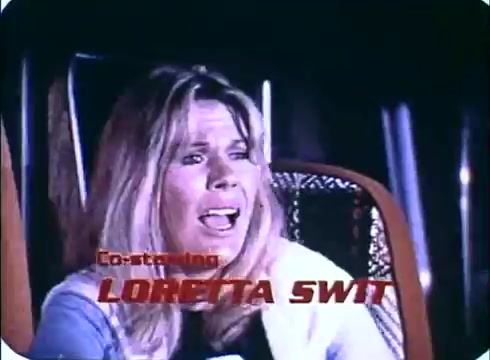 The still from the trailer of 'Race with the Devil' features Loretta Swit, who appears to be in a state of distress or fear. The scene emphasizes her emotional expression, likely conveying tension or anxiety related to the film's themes. The title 'Co-starring LORETTA SWIT' is prominently displayed in bold lettering, highlighting her role in the movie. The 16mm print captures the film's vintage aesthetic.