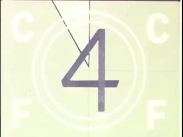 The still features a frame from a 16mm film leader, showcasing the number '4' prominently in the center. Surrounding the number are concentric circular patterns and letters 'C' and 'F' on either side. The overall design is typical of film countdowns, suggesting it is a preparatory shot for commercial footage. The color palette appears muted, characteristic of vintage film.