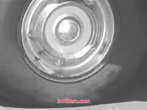 The still features a close-up of a car tire, showcasing the rim and the tread. The emphasis is on tire wear, highlighting the importance of vehicle safety. This visual correlates with the 1960s safety campaign, underscoring the need for regular checks to ensure safe driving.