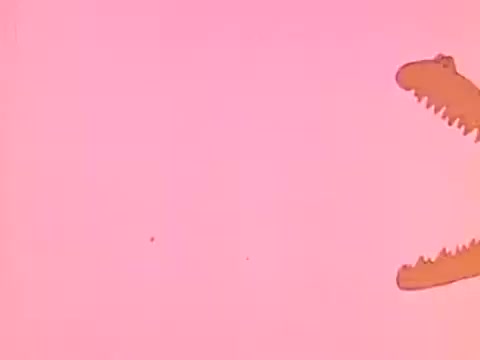 The still features a cartoonish alligator against a vibrant pink background, likely serving a humorous or engaging purpose in a 1970s American Association of Orthodontists commercial. The playful imagery appeals to children, possibly illustrating the importance of dental care. The style is characteristic of animated segments from that era, focusing on fun and education.   Follow us on Twitter @FromFilm.