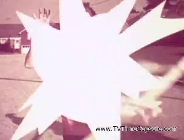 The still from the 'Lady Scott' commercials features a dynamic and playful scene, likely depicting a person engaging with colorful tissue products. The image shows a burst pattern, emphasizing fun and excitement, and suggests the use of bright, varied colors typical of the promotional style aimed at making paper products more appealing. The overall tone is light-hearted and whimsical, characteristic of advertising aimed at enhancing everyday items like tissues and paper towels.