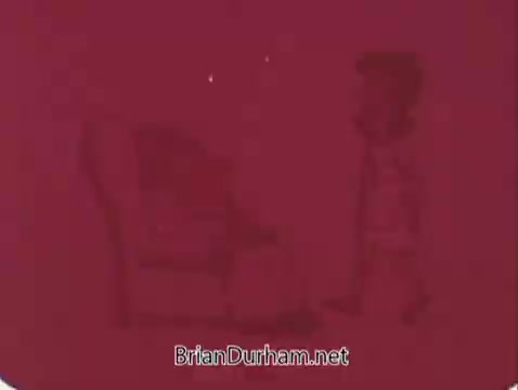 The still from 'Milk the 'Grade A' way' features a simple, animated scene with a character walking toward a large chair against a deep red background. The character appears jovial and cartoonish, suggesting a lighthearted approach typical of public service announcements from that era. The focus is on promoting milk as a wholesome choice.