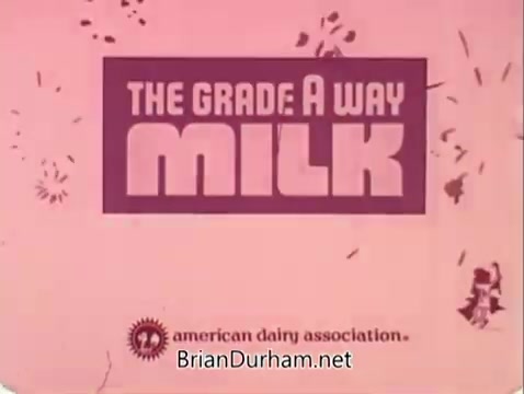The still features a bold, colorful title that reads 'THE GRADE A WAY MILK' against a pink background. The imagery is simple, focusing on the promotional message from the American Dairy Association. The design incorporates playful elements, emphasizing dairy education and quality.