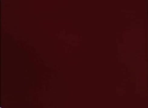 The still from the 1970s/1980s Nestlé Quik commercial features an anthropomorphic bunny character associated with Nesquik. This cartoon rabbit is known for wearing a prominent red 'Q' collar and has become emblematic of the brand. The commercial aimed to highlight the fun and playful nature of the product, appealing to children. The visual style is typical of the era's animated advertisements.