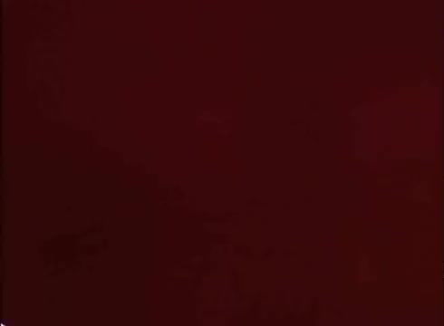 This still from a 1970s/1980s Nesquik commercial features the iconic Quik Bunny, an anthropomorphic rabbit known for promoting Nesquik products. The bunny is typically depicted wearing a collar with a prominent red 'Q.' The commercial aimed to appeal to children, highlighting the fun and tasty aspects of the chocolate and strawberry milk powders. The image, sourced from a 16mm print, reflects the vintage style of that era's advertising.