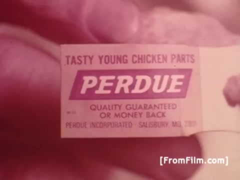 The still features a close-up of a label from a Perdue Chicken product, printed in vibrant colors. The label reads 'TASTY YOUNG CHICKEN PARTS' prominently, with the Perdue logo beneath it. The tagline emphasizes quality assurance, stating 'QUALITY GUARANTEED OR MONEY BACK.' The setting suggests a focus on fresh food, maintaining themes common in 1970s commercials.