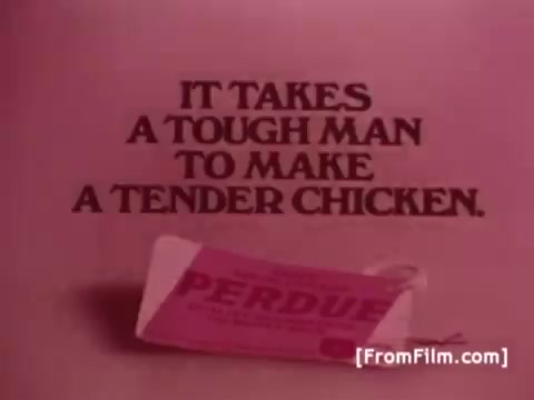 The still features bold text reading, 'IT TAKES A TOUGH MAN TO MAKE A TENDER CHICKEN,' prominently placed over a soft, pink background. Below the text, there is a partially visible Perdue Chicken product packaging, reinforcing the brand's identity. This image captures the essence of the 1970s advertising style, combining simplicity with a strong tagline.