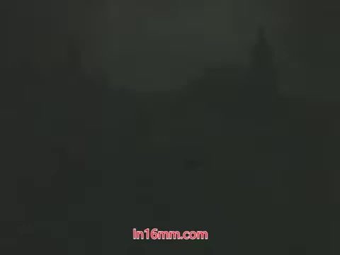 The still from the PSA features a dimly lit urban scene, likely depicting a cityscape affected by pollution. The overall aesthetic reflects the environmental concerns of the 1960s, showing an atmosphere shrouded in smog or haze. This aligns with Mason Adams' voiceover highlighting the adverse effects of polluted air, emphasizing the contrast between washable items and the inability to cleanse one's lungs. The message encourages public engagement in addressing air quality, urging viewers to take action for a healthier environment.