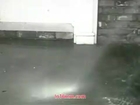 The still from the 1960s PSA highlights a damp and dirty floor, likely showcasing the impact of air pollution. The muted tones emphasize a grimy environment, in line with the voiceover discussing the pollution in cities. The imagery aims to evoke concern about air quality and the inability to cleanse lungs like physical objects. It serves as a visual prompt to encourage viewers to take action regarding air pollution.