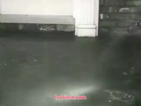 The still from the 16mm PSA 'Clean Air Public Health Service' featuring Mason Adams showcases the grimy floor of an urban environment, highlighting the effects of pollution. The setting likely includes elements suggesting neglect and dirt resulting from air pollution. The contrast between the unsightly floor and the clean, white architectural features conveys the message about the impact of polluted air on health. The voiceover emphasizes the inability to 'wash' one's lungs, urging viewers to take action toward cleaner air. Overall, the still serves as a visual reminder of the importance of air quality and public health advocacy.