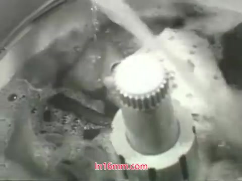 The still from the PSA features a close-up view of a washing machine in action. We see bubbles and water swirling around, emphasizing the cleansing process. This visual metaphor connects to the voiceover by Mason Adams, highlighting the idea that while we can wash away dirt and pollutants from our possessions, we cannot clean our lungs from the effects of polluted air. The machine represents a solution for tangible messes, contrasting with the negative impact of air pollution on health. The ad encourages awareness and action regarding air quality issues.