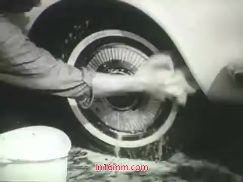 The still from the PSA features a close-up of a person washing a car tire and rim, highlighting the contrast between the act of cleaning and the message about air pollution. The washing is depicted in a monochrome style common in the 1960s, emphasizing grit and effort. The voiceover by Mason Adams reinforces the idea that while one can clean many things affected by pollution, the lungs cannot be washed. This visual reinforces the urgency of addressing air quality concerns.