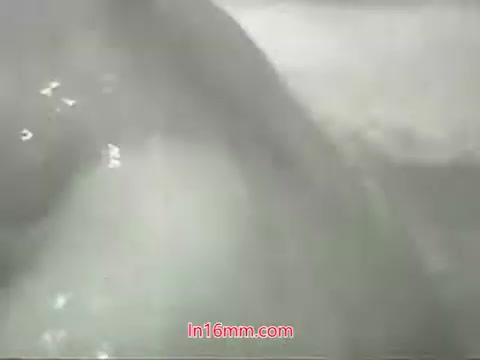 The still from the 'Clean Air Public Health Service PSA' featuring Mason Adams' voiceover likely depicts a close-up of water, possibly emphasizing cleanliness and the act of washing. The context of the PSA focuses on the issue of air pollution in urban settings and the impact it has on health, particularly highlighting the inability to 'wash' one's lungs despite the ability to clean surfaces. The visual might serve as a metaphor for the need to address air quality.