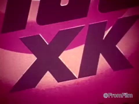 The still from the Tide XK laundry detergent commercial highlights the product's ability to remove tough stains. It features bold, stylized text 'Tide XK' against a vibrant background, conveying a message of innovation and effectiveness. The context suggests a humorous take on common household stain challenges, emphasizing the product's stain-fighting capability.