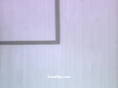 The still from the late 1950s UPA commercials features a simple animated design associated with the American Express brand. The background is light-colored with a subtle texture, while a prominent gray square outline suggests a focus on a central visual element, typical of UPA’s modernist style. This aesthetic aligns with UPA's innovative approach to animation during that era.