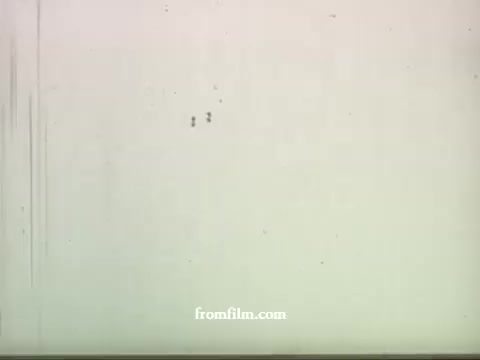 The 16mm still from the late 1950s UPA commercials features a blank or textured background, with a few faint markings or imperfections typical of film degradation. This specific still is from a series of commercials, likely showcasing a creative approach to advertising, which UPA was known for during that era. The style aligns with their innovative animation techniques, previously highlighted in works like 'Gerald McBoing Boing' and 'Mr. Magoo'. The focus on American Express suggests a combination of playful animation and branding typical of UPA's commercial work.